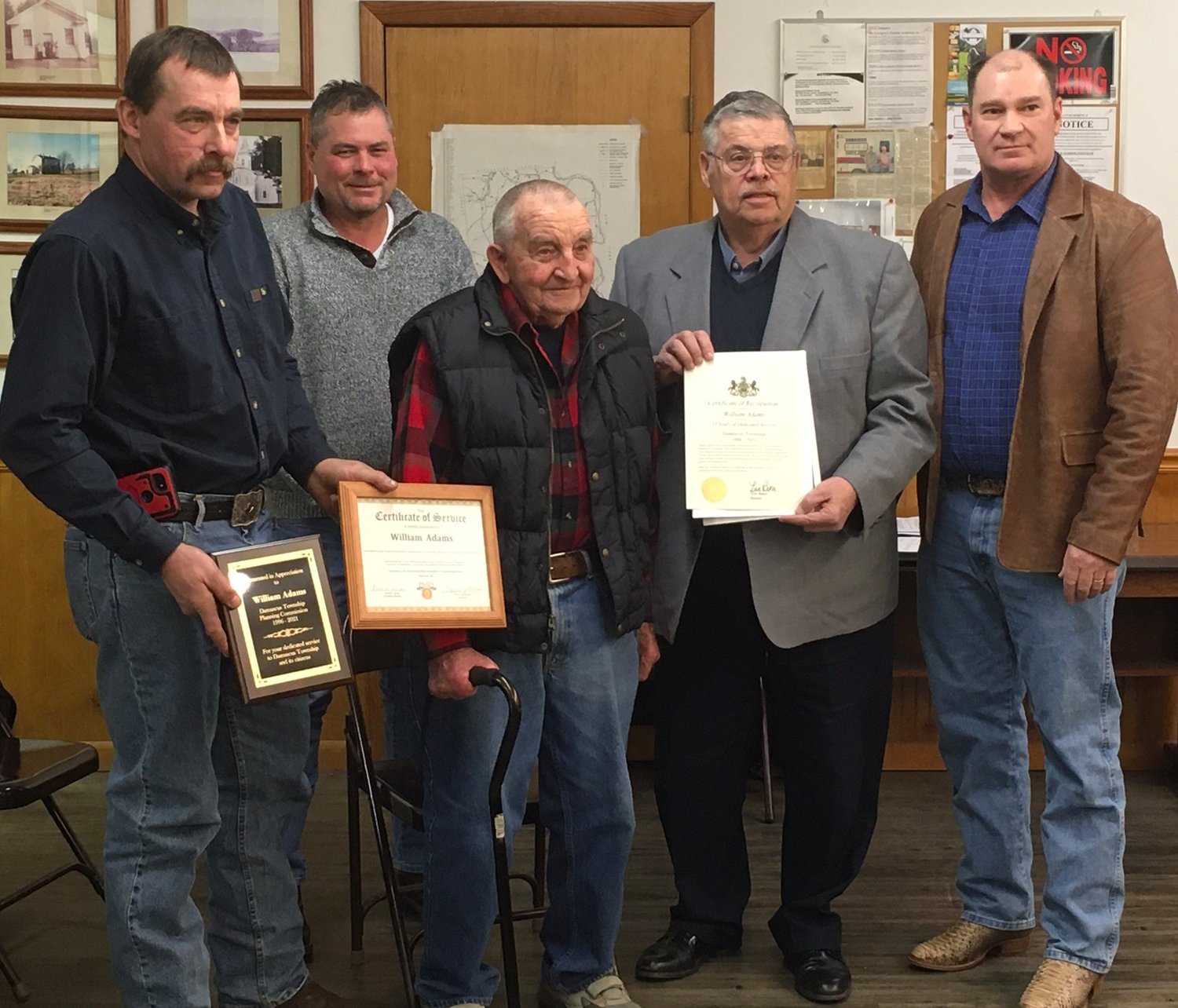 William (Bill) Adams, center, is flanked with this certificates and plaques for his 25 years of service to the Damascus Township Planning Board. To his left, supervisor Joseph Canfield holds one of the plaques, while Tony Herzog, representing Senator Lisa Baker's office, is to the right. Daniel Rutledge, back row, and supervisor Steve Adams pose for the moment.